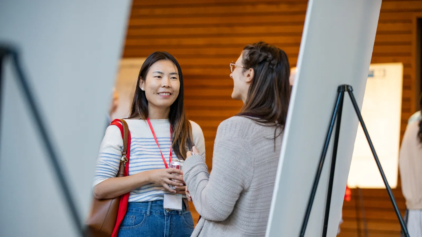 A researcher presenting their poster