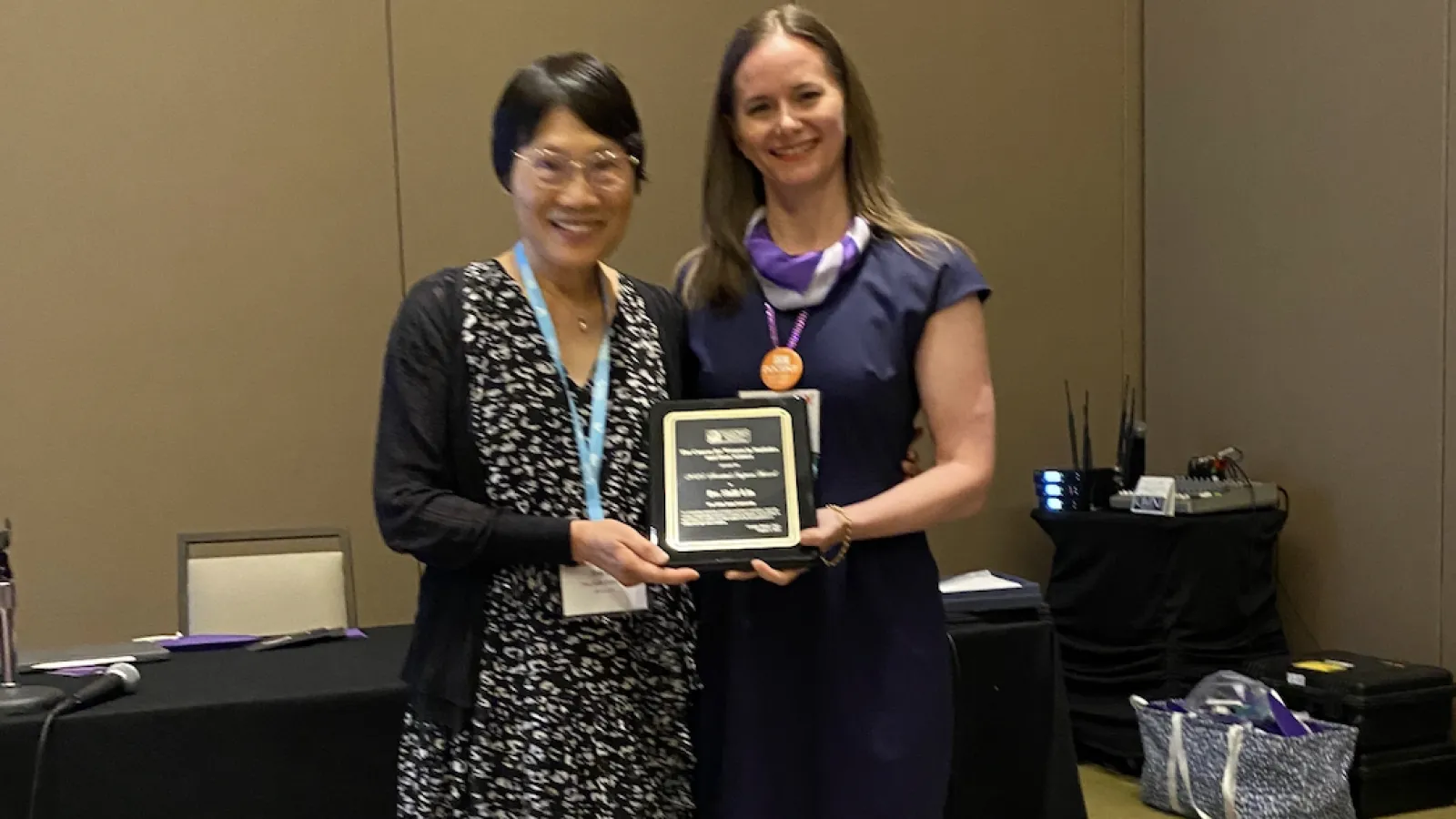 Shili Lin with a plaque at the JSM