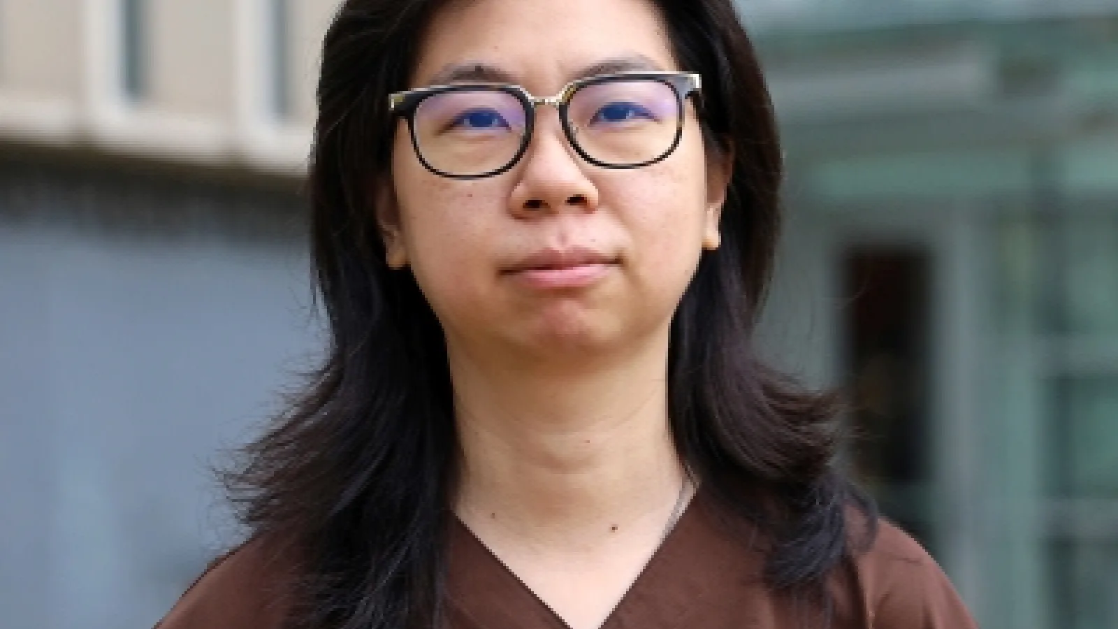 Qianying standing outside in front of a campus building
