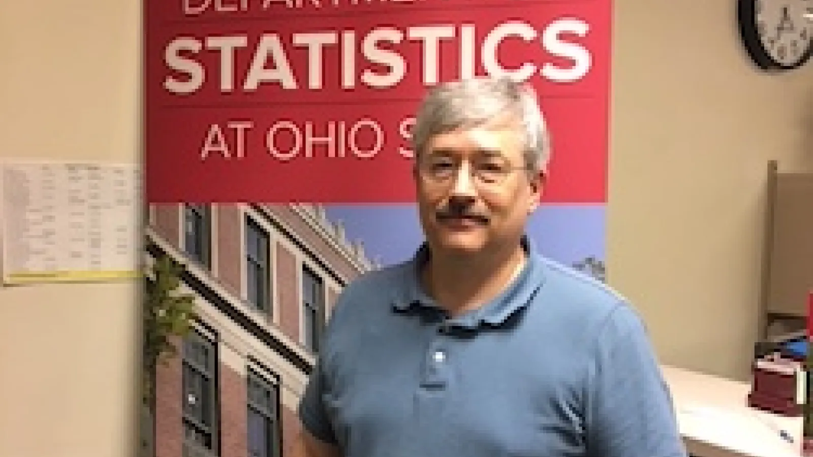 Paul Brower in front of Department of Statistics sign.