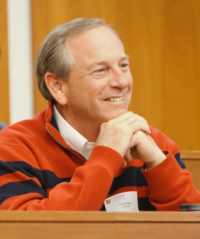 Tom Bishop sitting and smiling