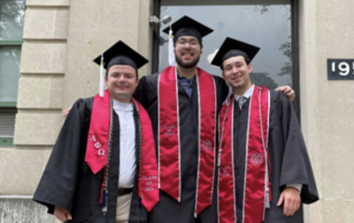 three graduates in caps and gowns