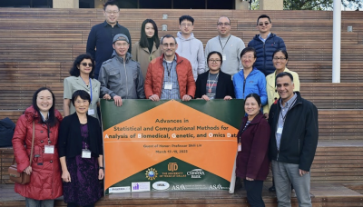 Dr. Shili Lin and conference organizers holding a banner