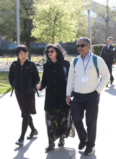 Dr. Shili Lin walking with alumni