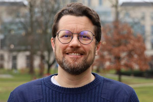 Headshot of Eben Kenah, the speaker of this event.