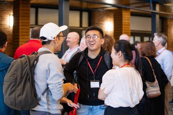 Alumni and students laughing