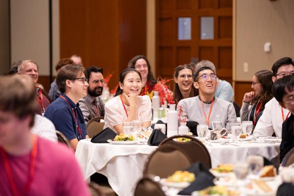 Banquet attendees sitting at a table and listening to the keynote lecture