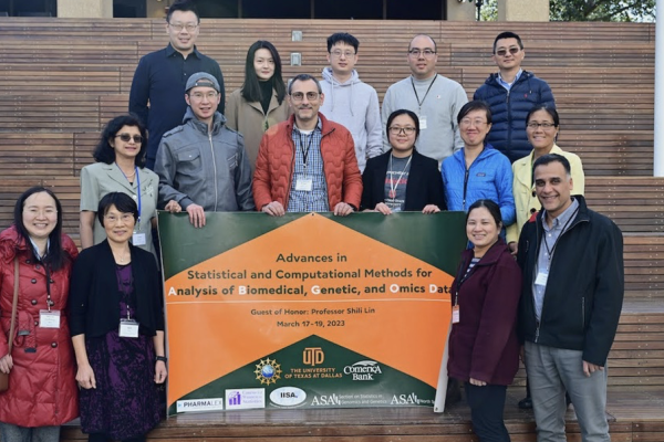 Dr. Shili Lin and conference organizers holding a banner
