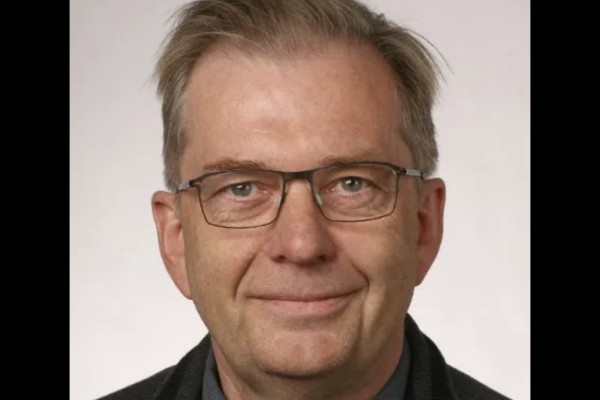Gunnar Stefansson smiling in front of a white backdrop