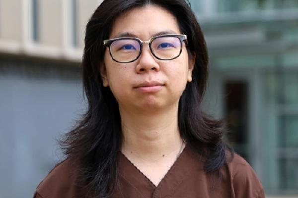 Qianying standing outside in front of a campus building