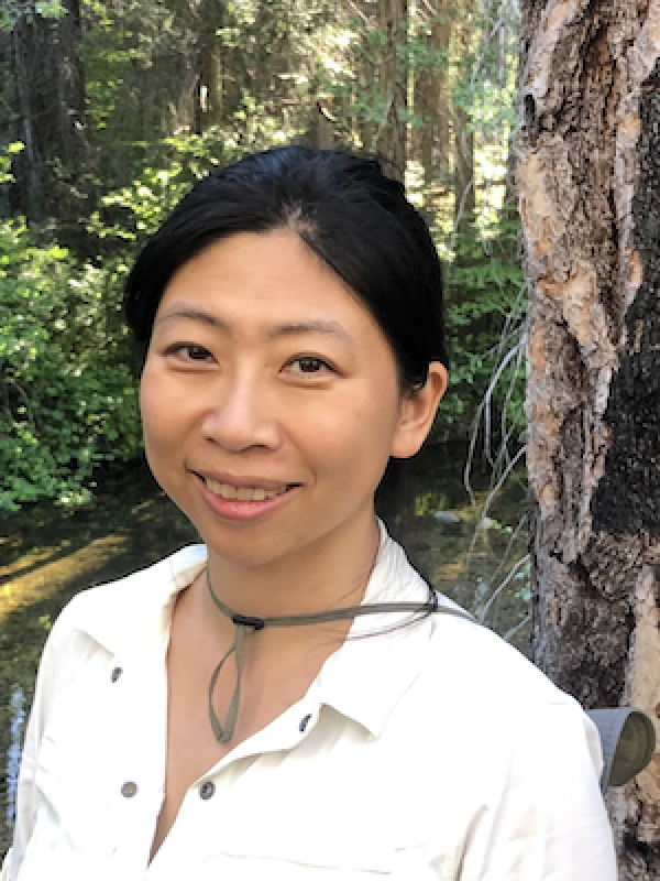 Kate Hu standing in front of trees