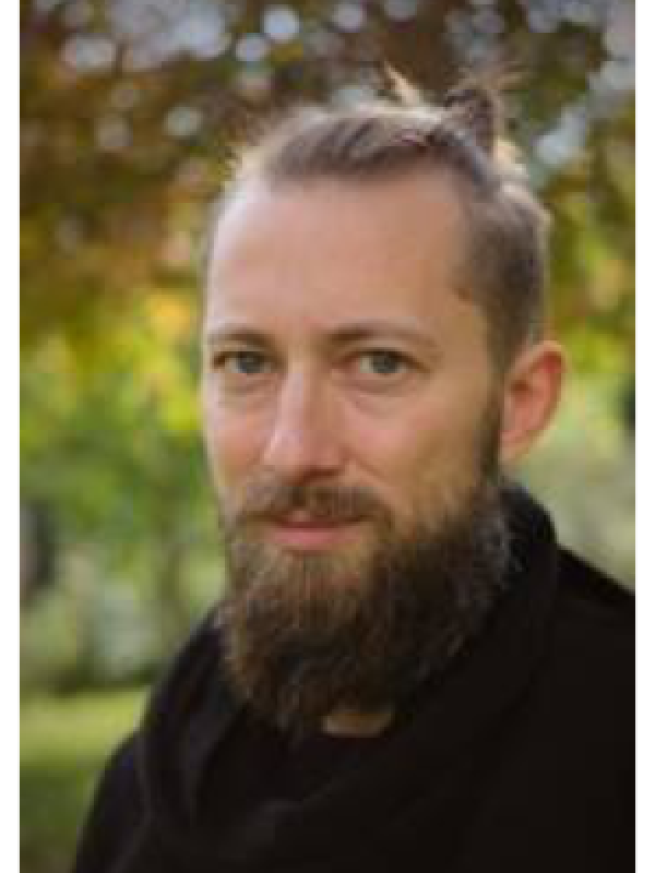 Paul Wiemann standing in front of trees