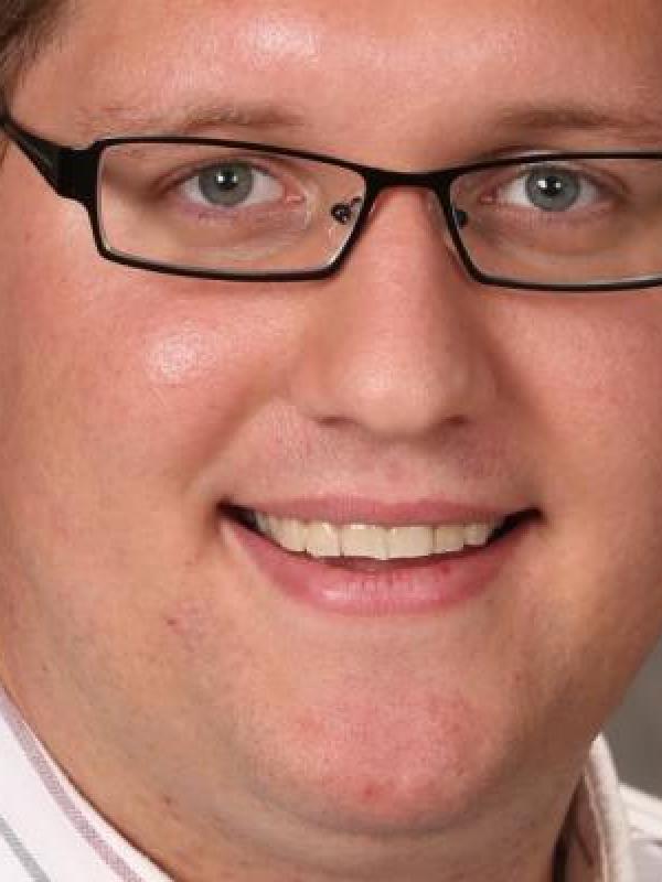 Lecturer Stephen Colegate posing for a professional headshot. 