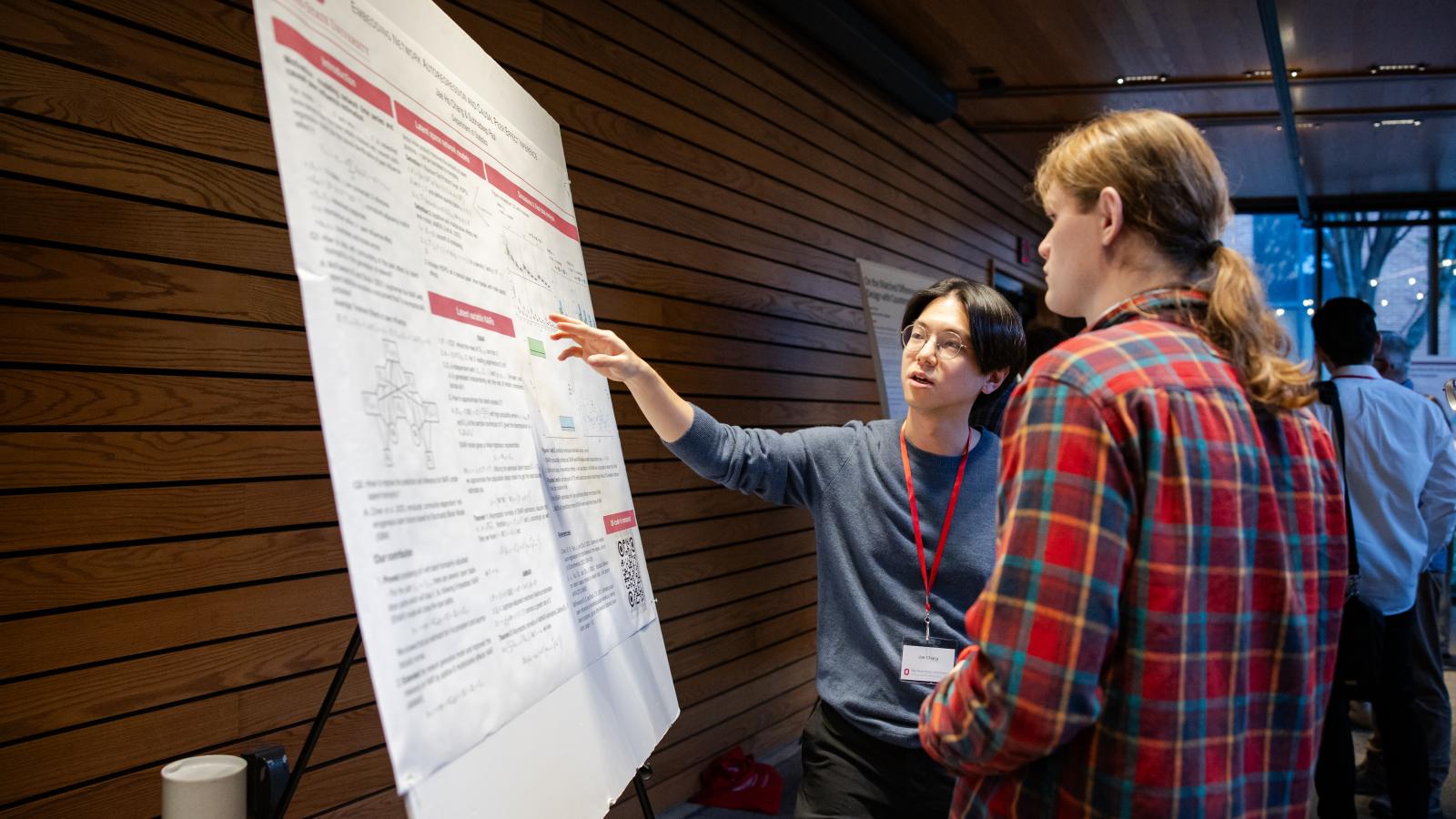 A researcher presenting their poster