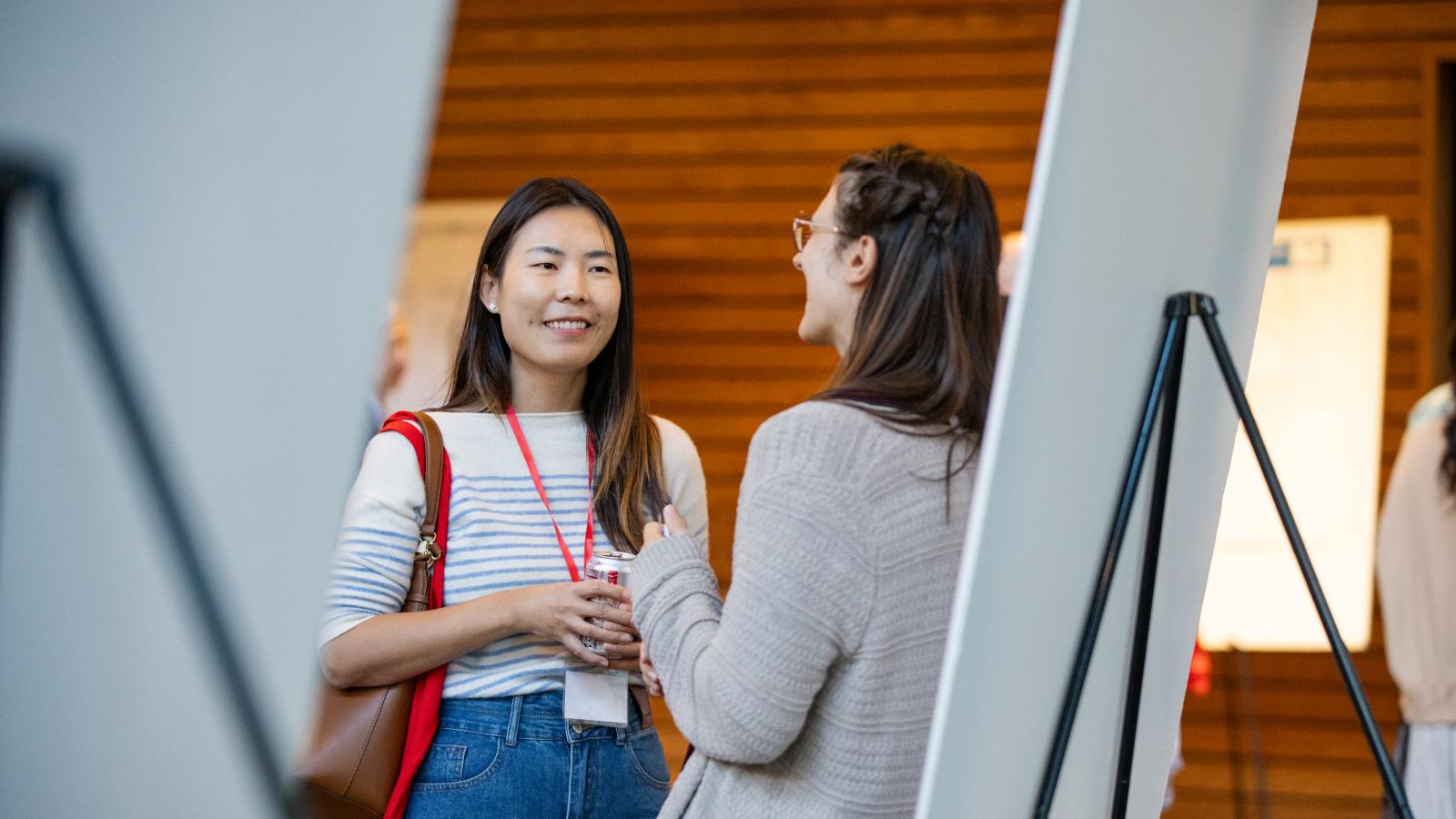 A researcher presenting their poster