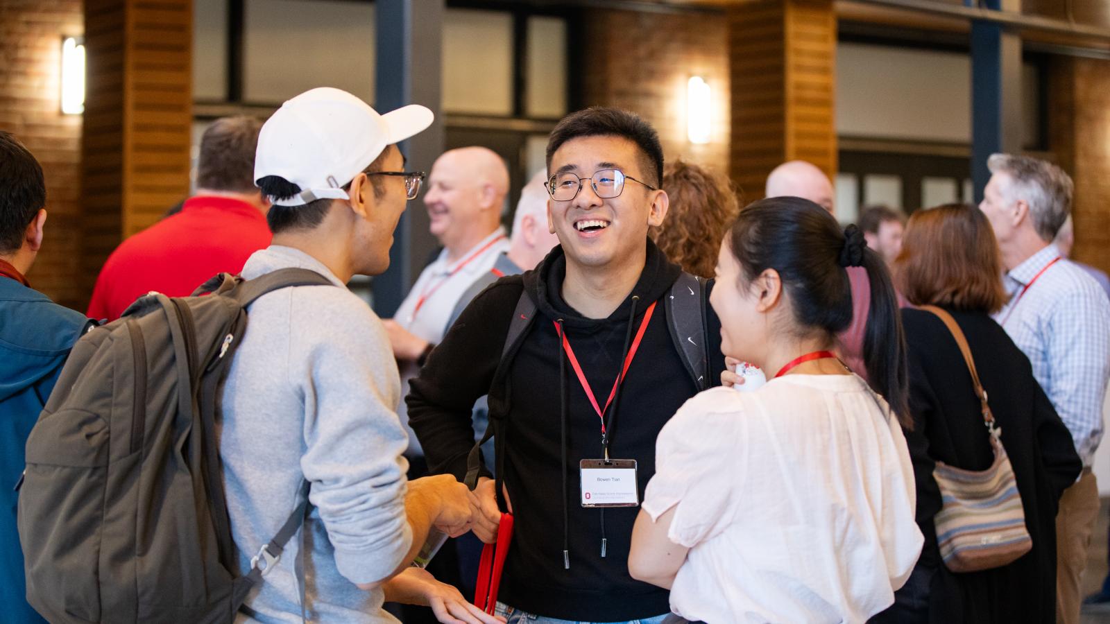 Alumni and students laughing