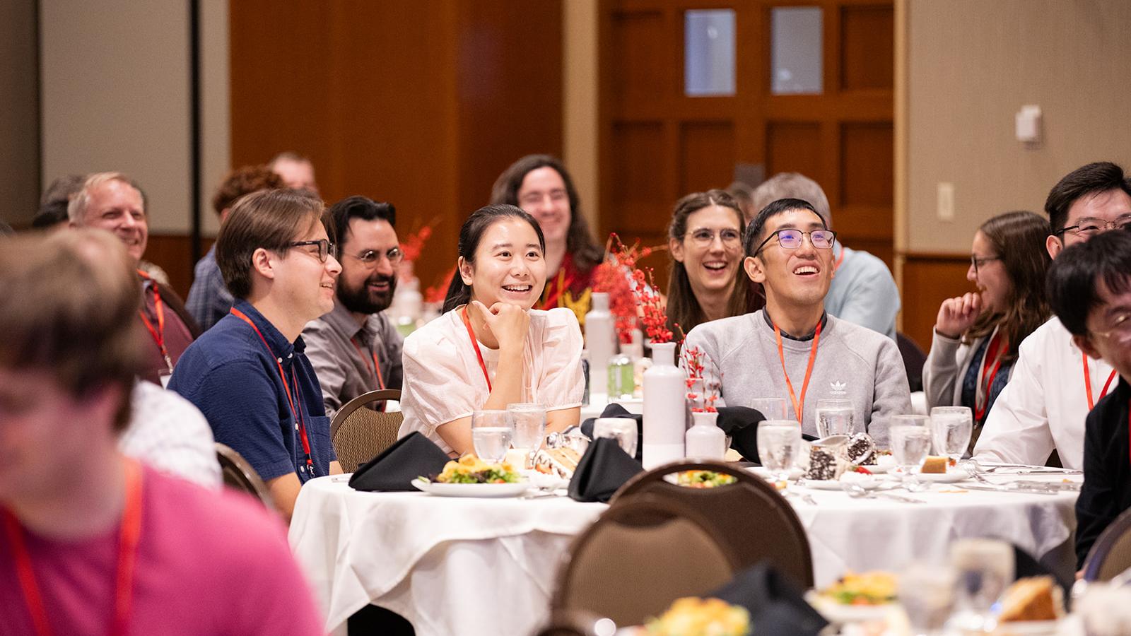 Banquet attendees sitting at a table and listening to the keynote lecture