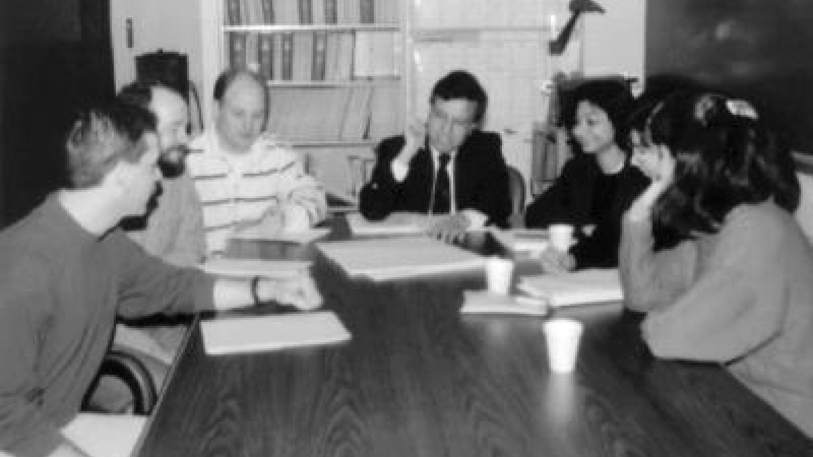 black and white image of Prem Goel and students sitting around a table