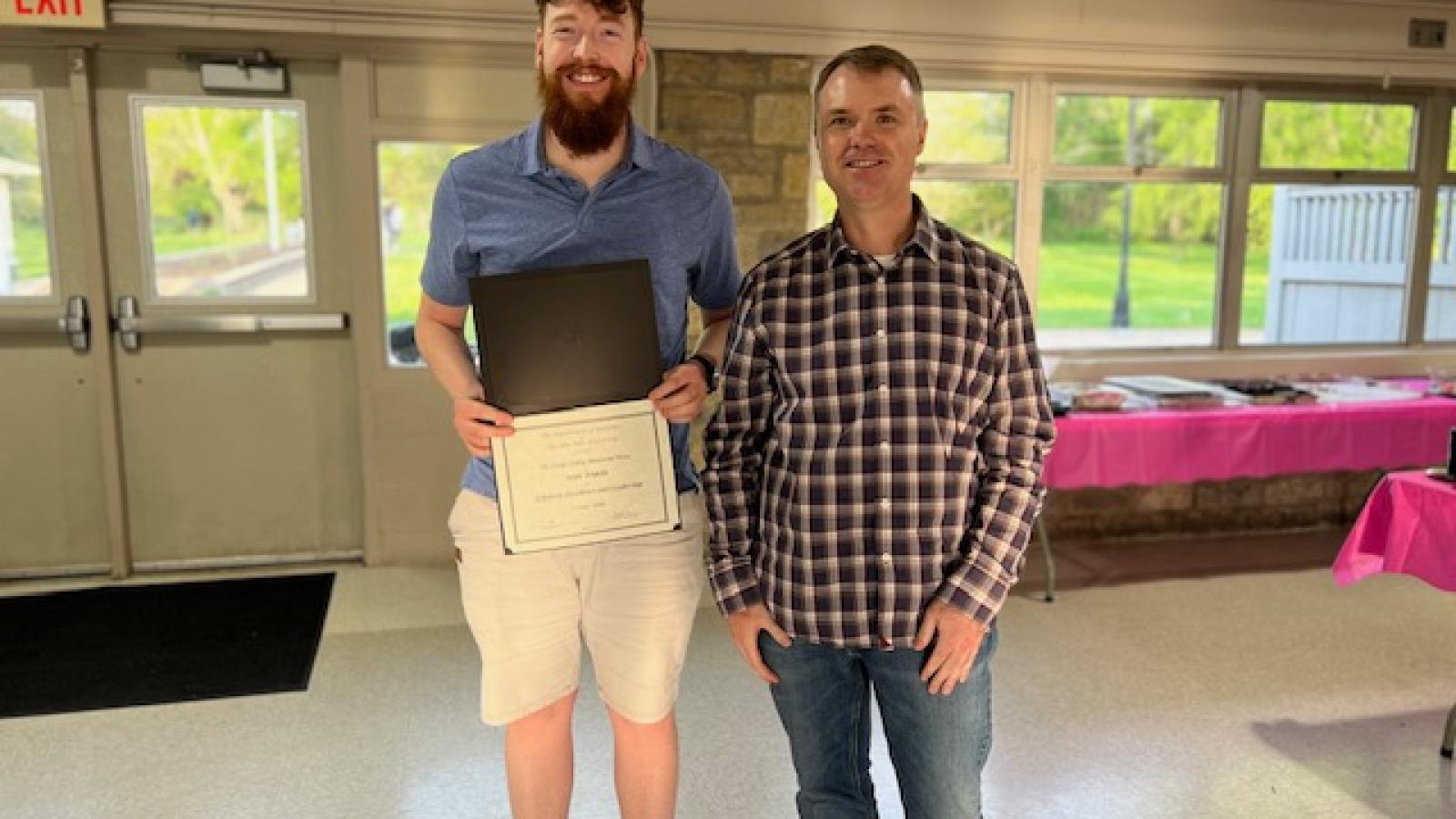 Chris Hans and Sean Tomlin, holding a certificate.