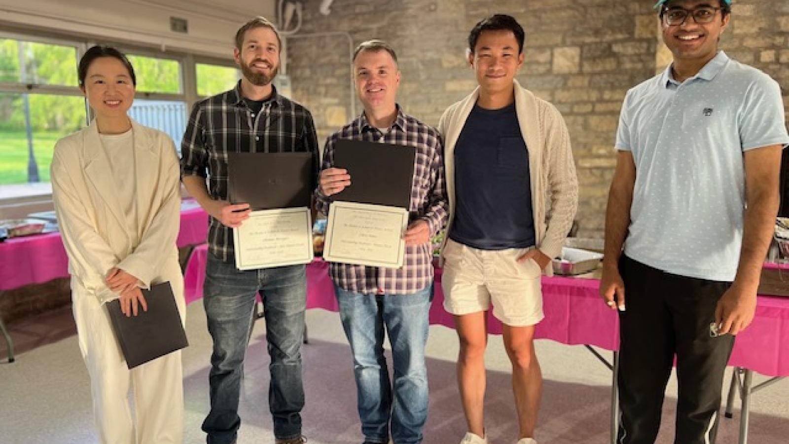 Yue Ma, Thomas Metzger, Christopher Hans, Alan Gan, and Arko Gupta standing in a row in a pavilion