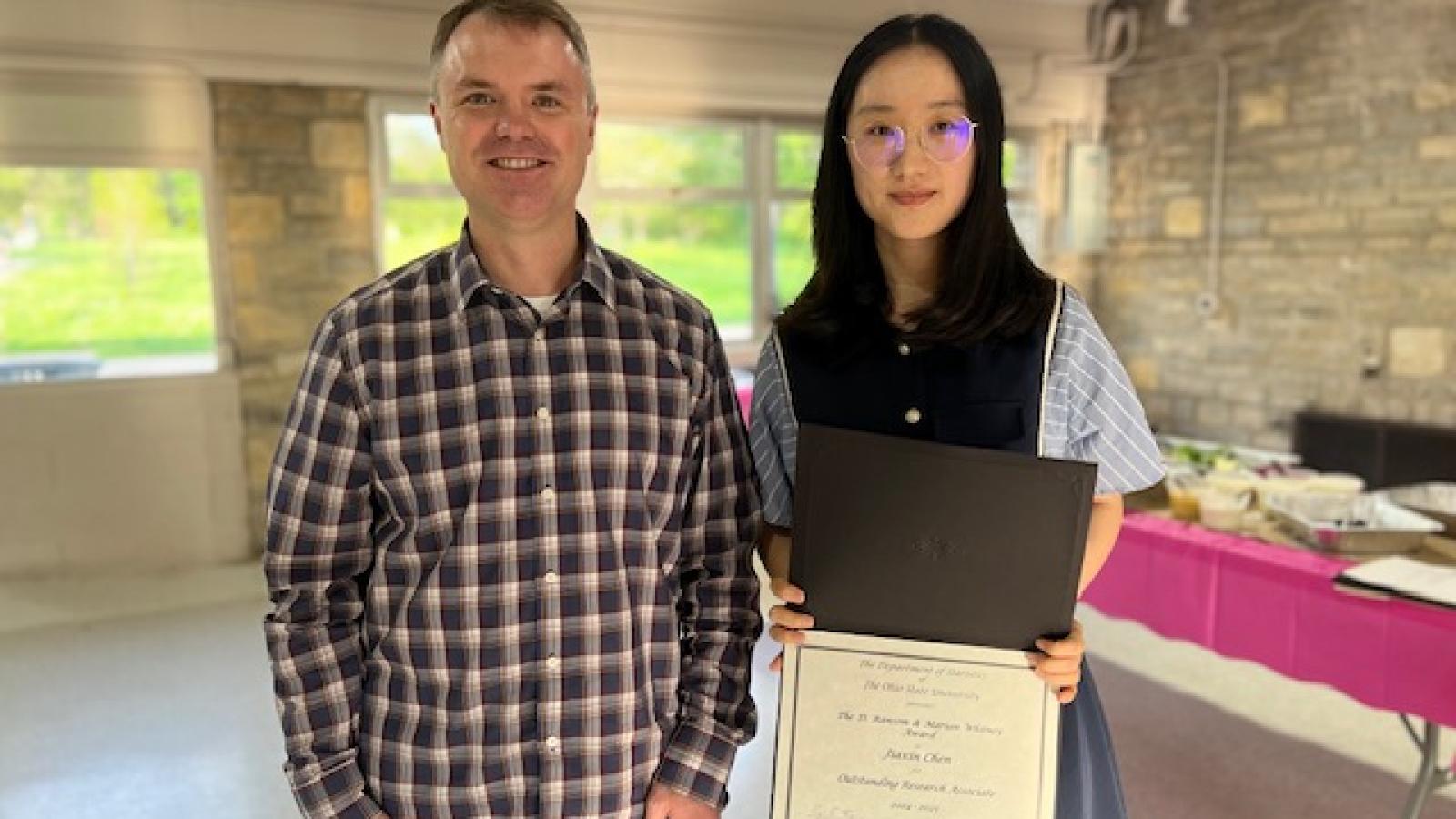 Chris Hans and Whitney RA Award recipient Jiaxin Chen standing together holding a certificate